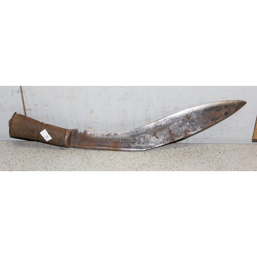 1404 - A vintage Kukri knife in sheath, seemingly unmarked and a 1951 dated leather US Police magazine hold... 