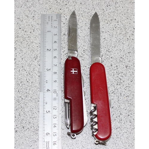 1440 - Victorinox knife in black case and a red Swiss army knife