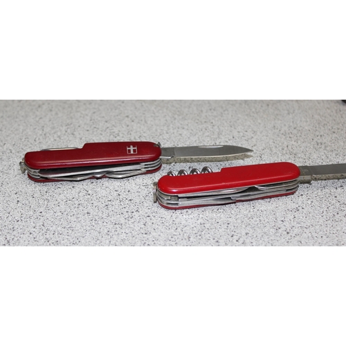 1440 - Victorinox knife in black case and a red Swiss army knife