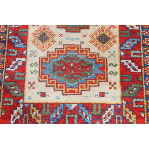 206 - A colourful vintage rug, approx 140cm x 80cm