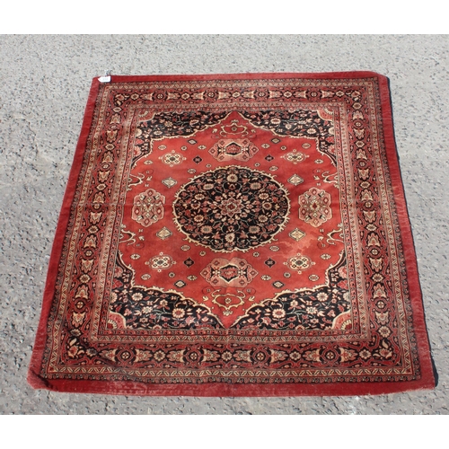 212 - Vintage red ground rug with central black medallion, approx 135cm x 150cm