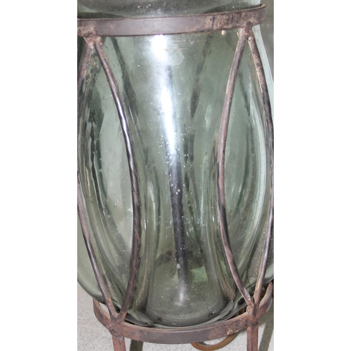 253 - Interesting hand-blown glass lamp set in wrought iron base with shade, approx 61cm tall