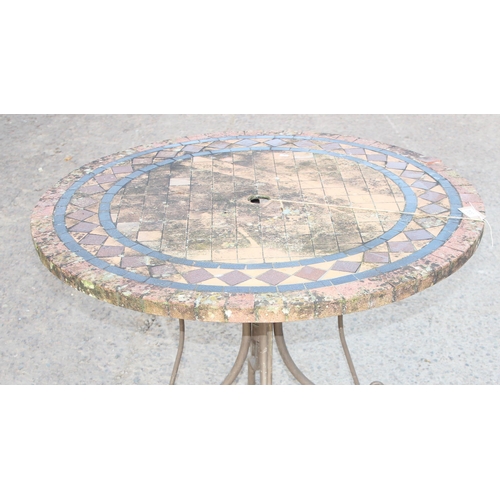 332 - Mosaic effect tile topped garden table with wrought iron base, approx 100cm in diameter x 75cm tall