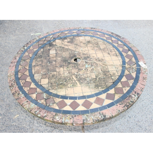 332 - Mosaic effect tile topped garden table with wrought iron base, approx 100cm in diameter x 75cm tall