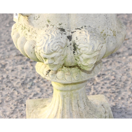 335 - A weathered concrete or stone garden planter formed as a classical urn with 4 heads, approx 49cm in ... 