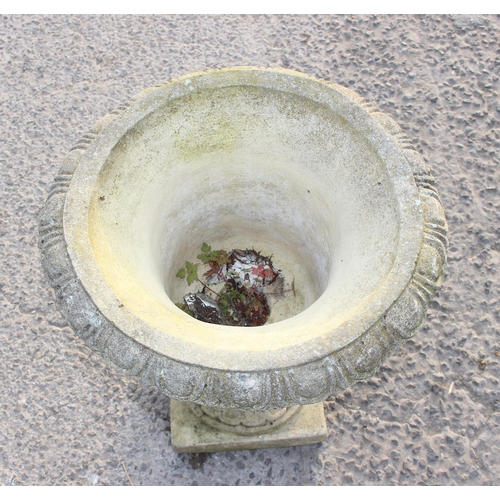 335 - A weathered concrete or stone garden planter formed as a classical urn with 4 heads, approx 49cm in ... 