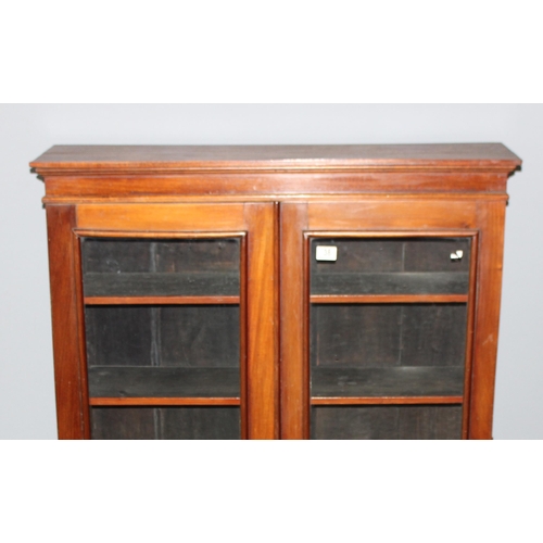 38 - Victorian glazed mahogany bookcase on bun feet, approx 96cm wide x 28cm deep x 123cm tall