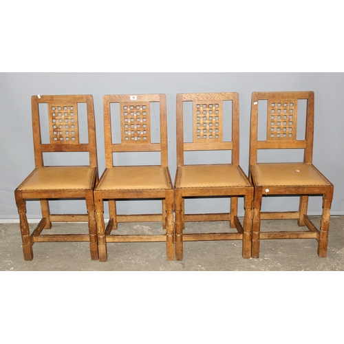 42 - Robert 'Mouseman' Thompson - A set of 4 Oak lattice backed dining chairs, with studded leather seats... 