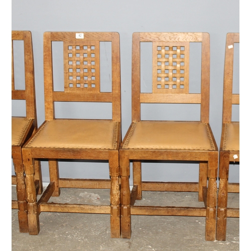 42 - Robert 'Mouseman' Thompson - A set of 4 Oak lattice backed dining chairs, with studded leather seats... 