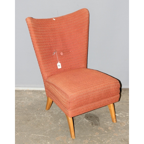 47 - A retro low chair with salmon coloured upholstery, approx 90cm tall