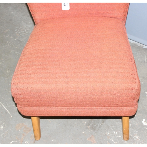 47 - A retro low chair with salmon coloured upholstery, approx 90cm tall