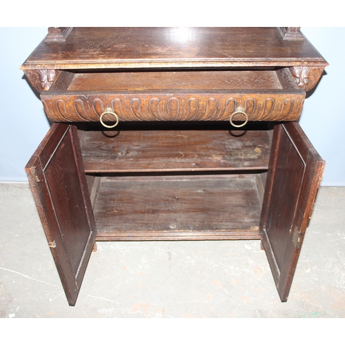 64 - An interesting highly decorative 17th century style carved oak bookcase cupboard with single drawer,... 