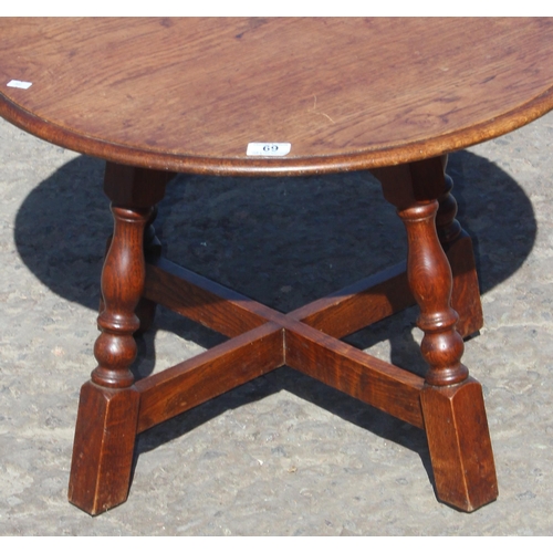 69 - A vintage round oak table with X stretcher, approx 60cm in diameter x 42cm tall