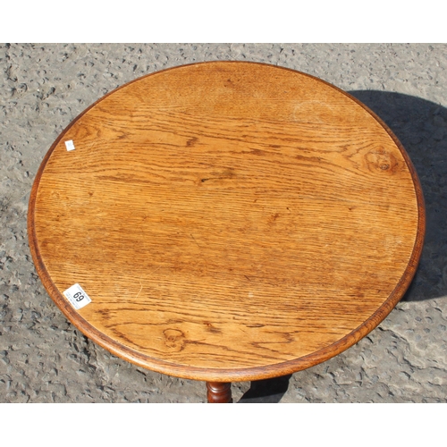 69 - A vintage round oak table with X stretcher, approx 60cm in diameter x 42cm tall