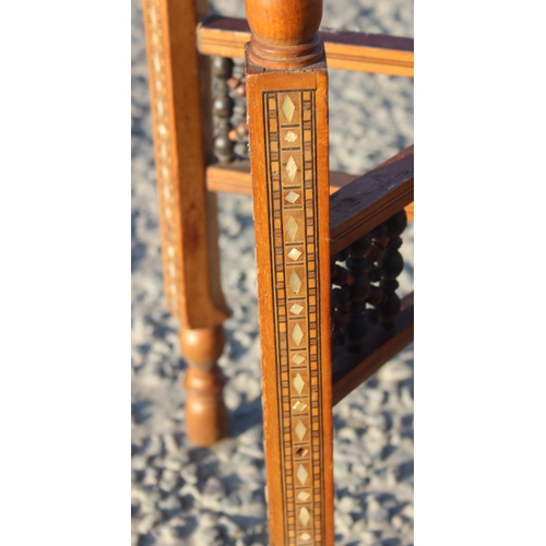 78 - A Benares brass topped tray table with folding wooden base, the top approx 56cm in diameter