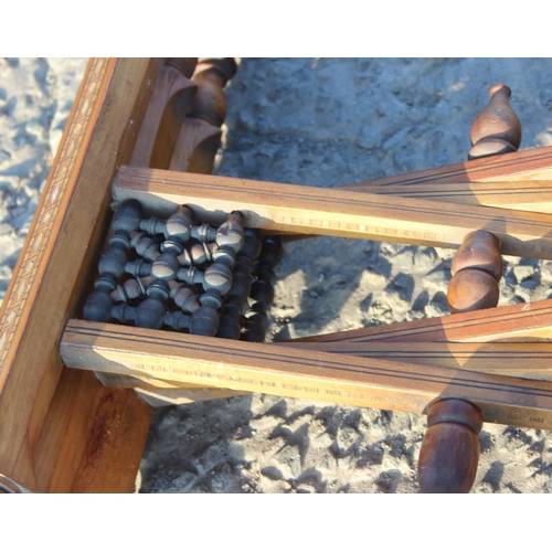 78 - A Benares brass topped tray table with folding wooden base, the top approx 56cm in diameter