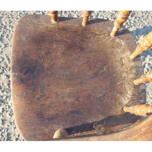 80 - A vintage oak or elm seated smokers bow or captain's armchair, likely early 20th century, approx 62c... 