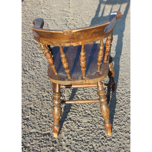 80 - A vintage oak or elm seated smokers bow or captain's armchair, likely early 20th century, approx 62c... 