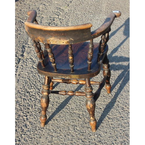 81 - A vintage oak or elm seated smokers bow or captain's armchair, likely early 20th century, approx 62c... 