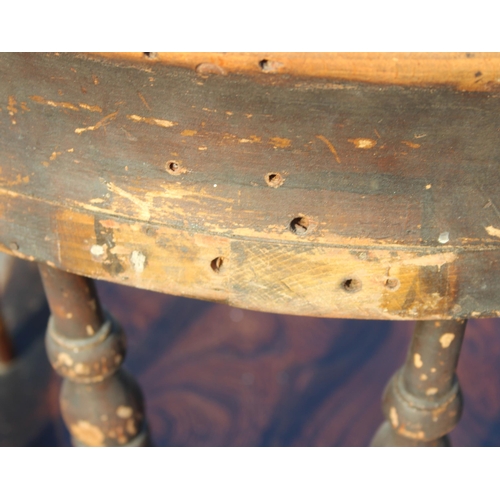 81 - A vintage oak or elm seated smokers bow or captain's armchair, likely early 20th century, approx 62c... 