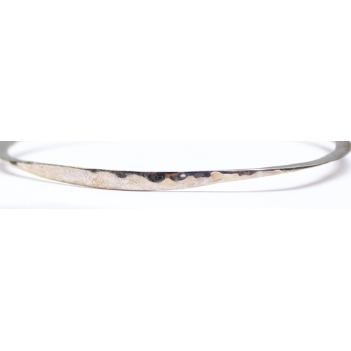 1139 - A retro 925 silver hammered bangle in Brooker & Breeze box