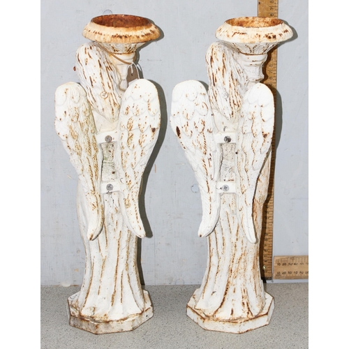 358 - Pair of heavy cast iron candlesticks formed as angles, each stand approx 46cm high