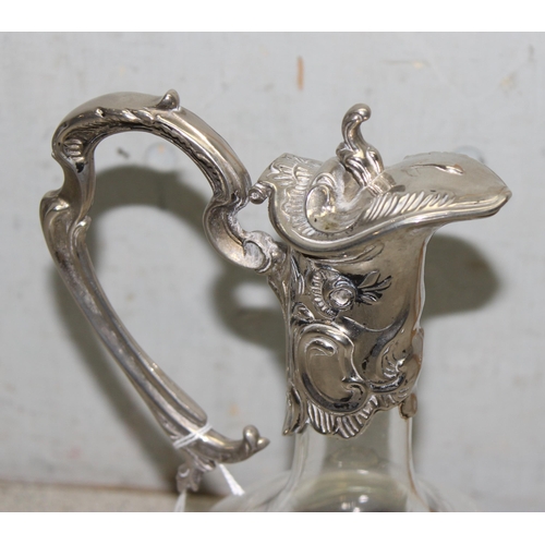 1050 - Antique ornate silver-plate mounted glass claret jug, approx