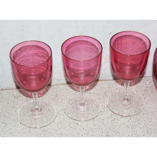 1633 - Cranberry glass pitcher and 6 wine glasses