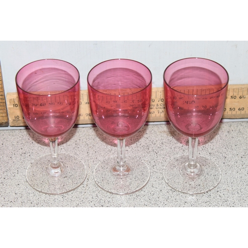 1633 - Cranberry glass pitcher and 6 wine glasses