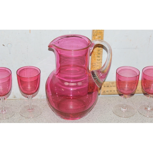 1633 - Cranberry glass pitcher and 6 wine glasses