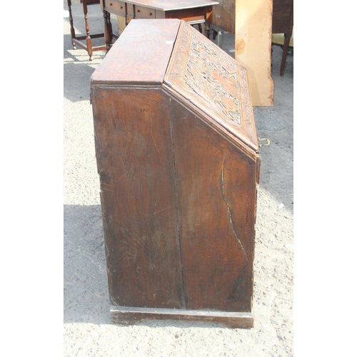 118 - An impressive profusely carved oak bureau, likely Georgian with later carving of a theatrical nature... 