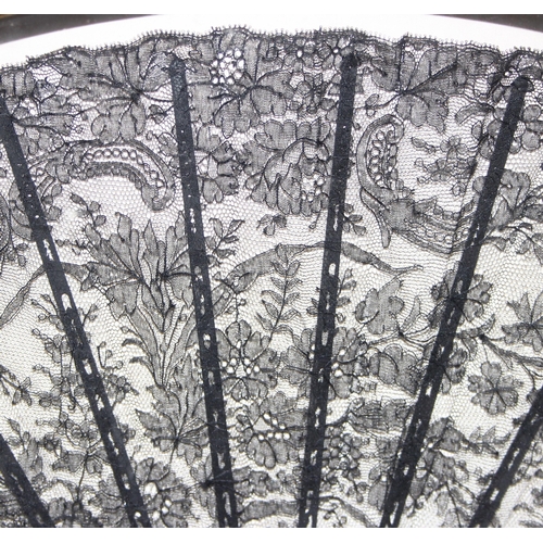 1641 - A 19th century black lace fan decorated with floral sprigs, the sticks and guard made from tortoises... 