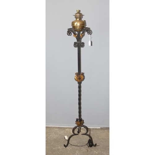 251 - An antique wrought iron oil lamp, later converted to electricity, approx 187cm tall