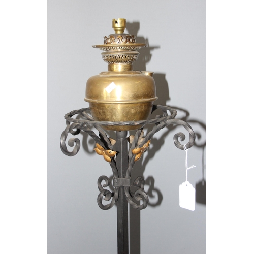 251 - An antique wrought iron oil lamp, later converted to electricity, approx 187cm tall