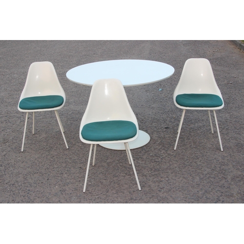 26 - A retro Arkana tulip table and 3 matching chairs, the table and the chairs all with moulded marks, t... 