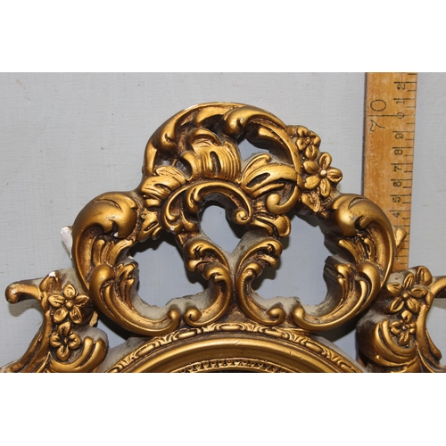 467 - Gilt framed shield shaped wall hanging mirror with classical design approx. 73cm x 42cm