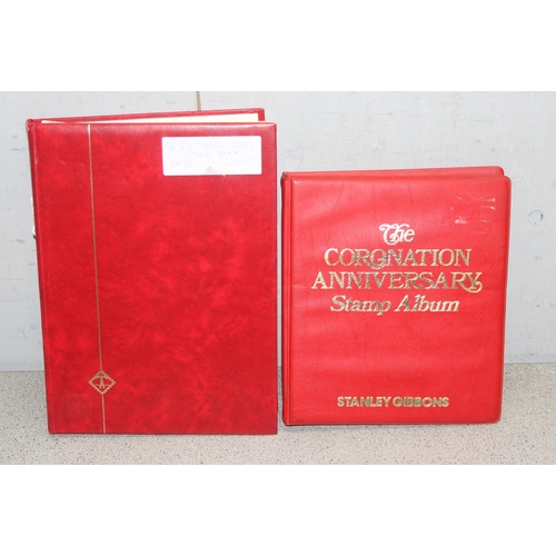 543 - 2 stamp albums to include a Stanley Gibbons coronation anniversary album and another loose stamp alb... 