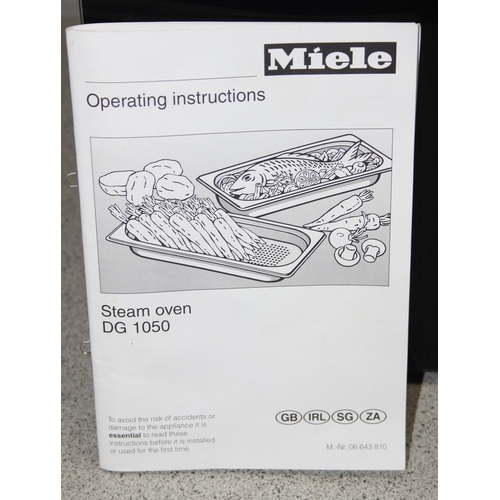 825 - Miele Steam Oven DG 1050 with accessories and instruction manual, seemingly unused