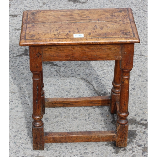 41B - An 18th century oak coffin stool standing on turned legs joined by stretchers, approx 46cm wide x 26... 