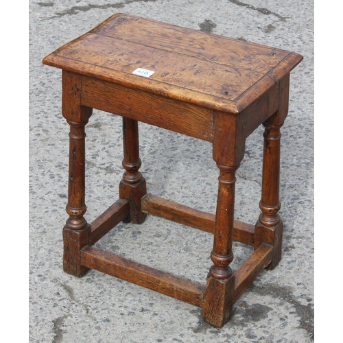 41B - An 18th century oak coffin stool standing on turned legs joined by stretchers, approx 46cm wide x 26... 