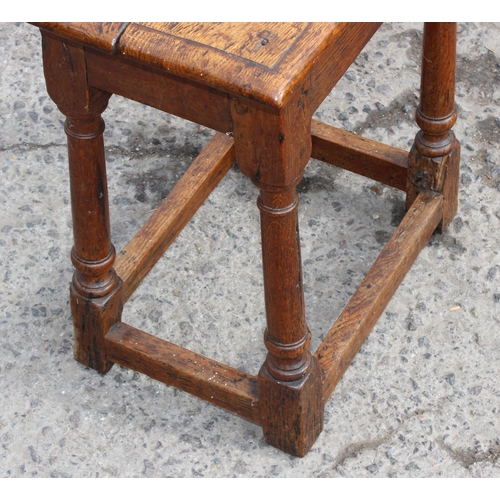 41B - An 18th century oak coffin stool standing on turned legs joined by stretchers, approx 46cm wide x 26... 