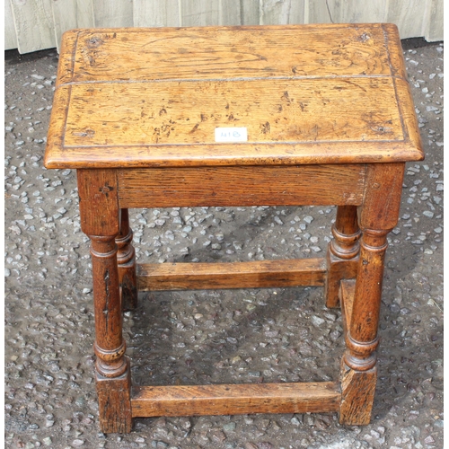 41B - An 18th century oak coffin stool standing on turned legs joined by stretchers, approx 46cm wide x 26... 