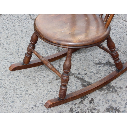 18 - Antique elm spindle-back rocking chair with penny seat, approx 95cm tall