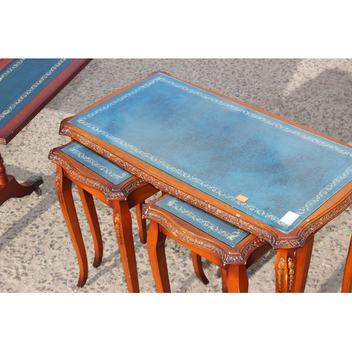 29 - Antique style reproduction leather topped drop-leaf low table on castors, and a similar nest of tabl... 