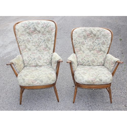 24 - A pair of retro his & hers Ercol armchairs with floral upholstered cushions