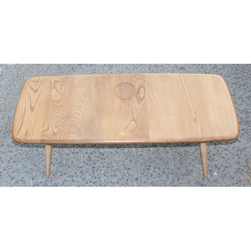 25 - A retro mid-century blonde Ercol coffee table with elm top and original blue label, approx 105cm W x... 