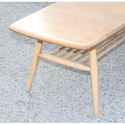 25 - A retro mid-century blonde Ercol coffee table with elm top and original blue label, approx 105cm W x... 