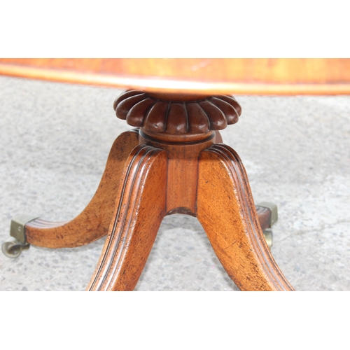 6 - Victorian mahogany tilt-top breakfast table with brass castors, approx 128cm W x 72cm H