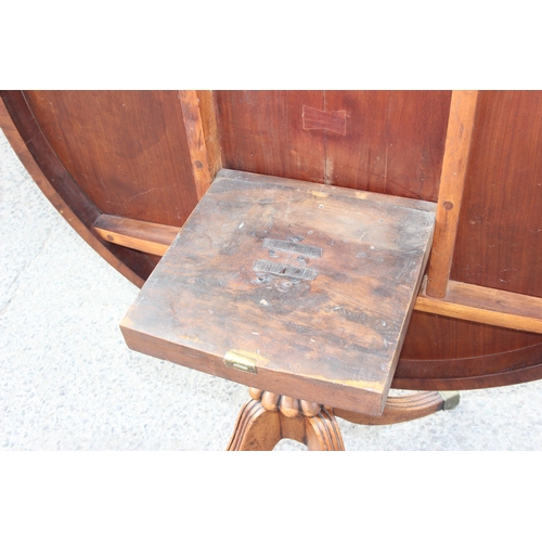 6 - Victorian mahogany tilt-top breakfast table with brass castors, approx 128cm W x 72cm H