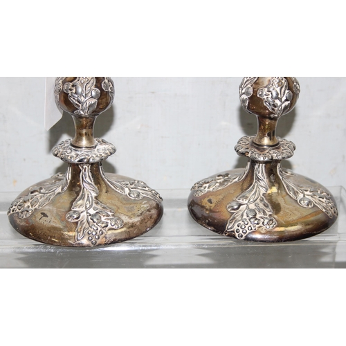 1008 - A pair of antique silver plated candlesticks, seemingly unmarked, each approx 24cm tall